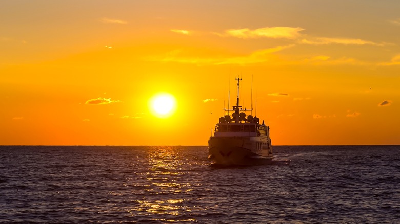 sunset with a boat in silhouette