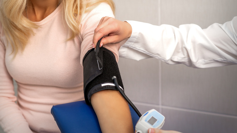 woman having blood pressure taken