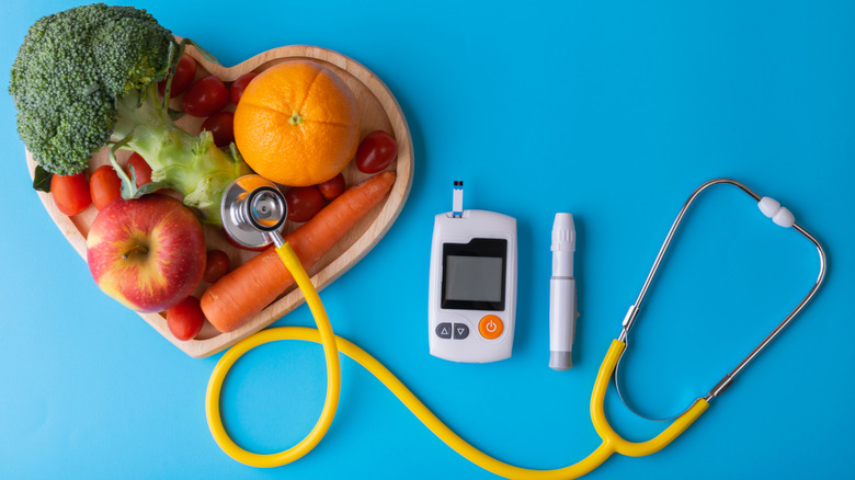 Fruits and veggies with diabetes monitor and stethoscope