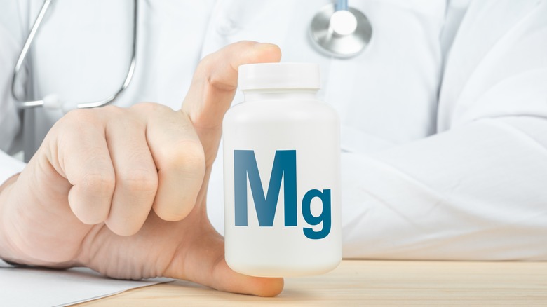 Doctor holding bottle of magnesium