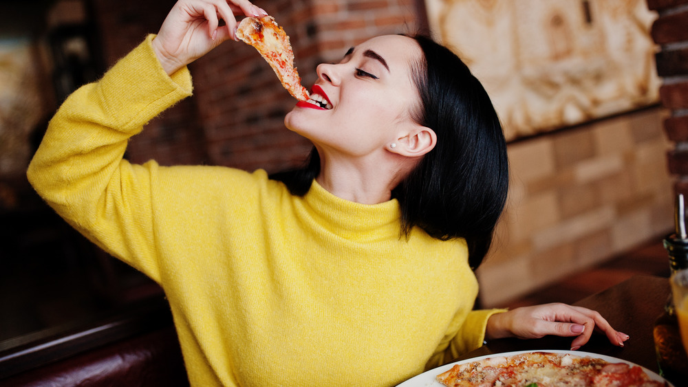 woman eating pizza