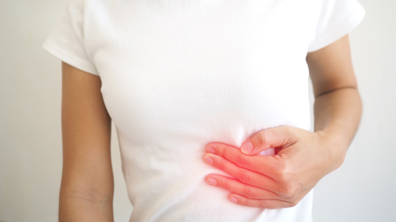 Woman pointing to her spleen