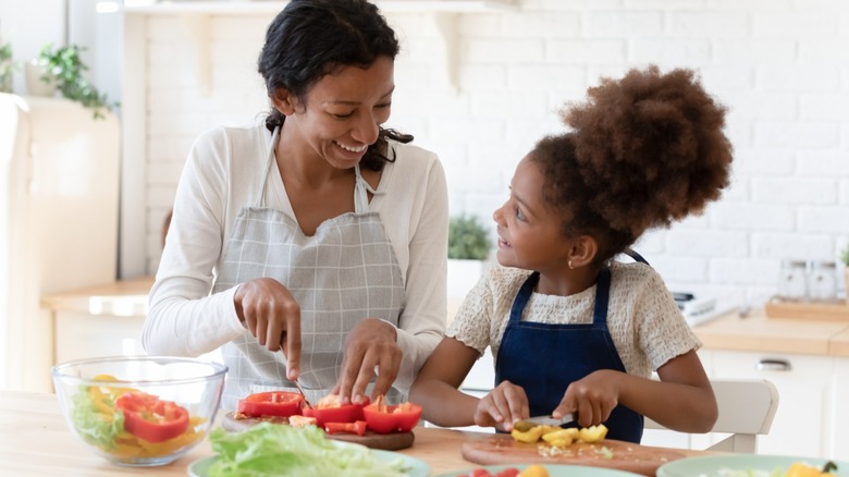 mother and daughter making salad