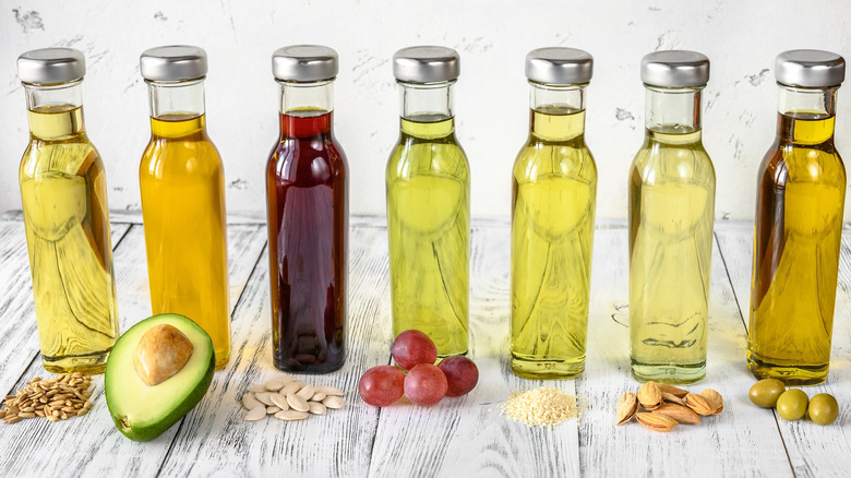 different oils set up on glass bottles with their foods