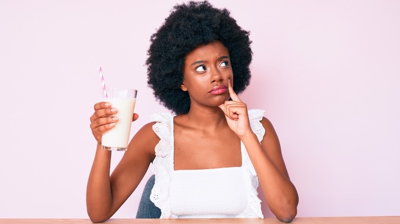 woman questioning healthiest milk