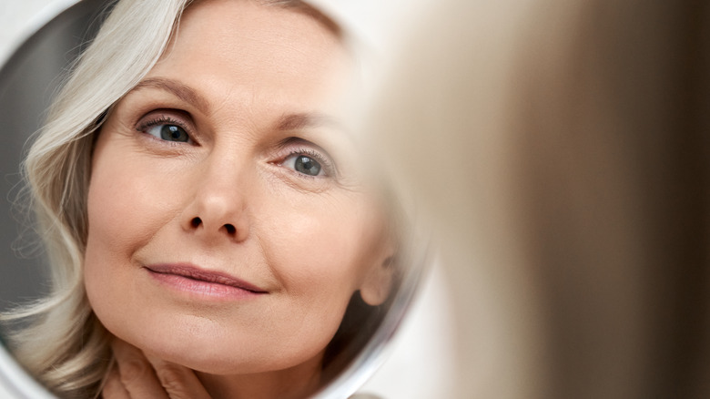 aging woman looking in the mirror