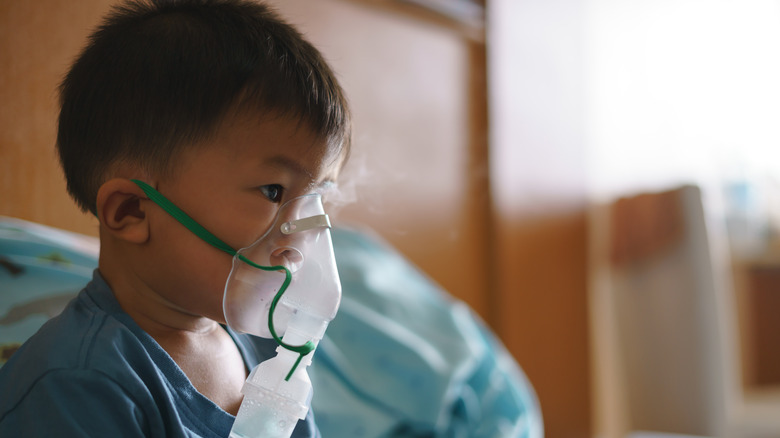 A young boy with a breathing mask