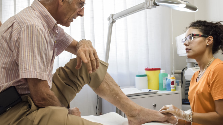 Healthcare provider treating patient's foot