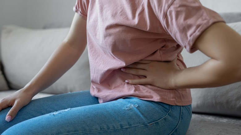 Woman holding stomach