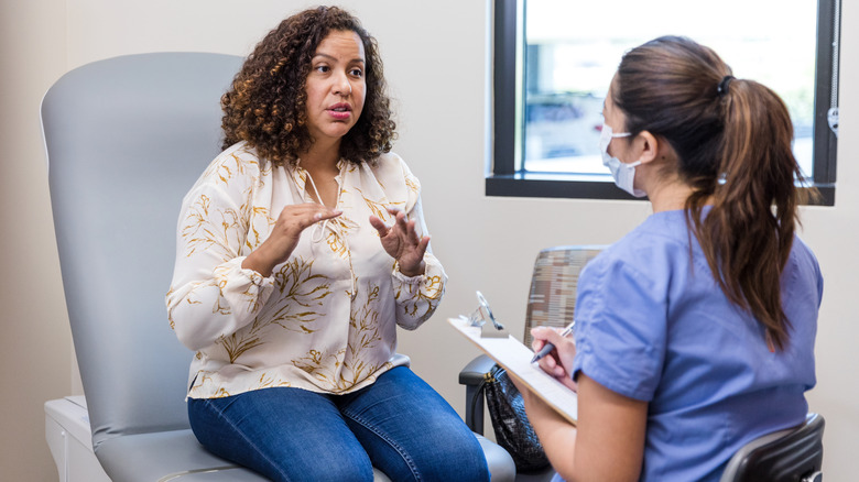 Woman speaking to gynecologist