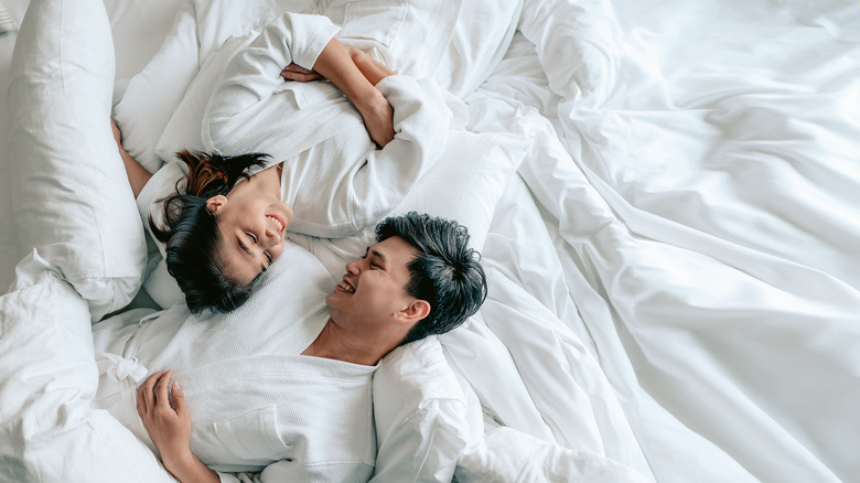 couple laying together in bed