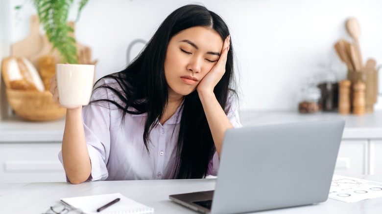 woman falling asleep at her desk