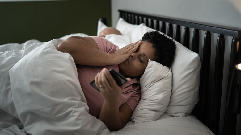 woman rubbing eyes after sleep