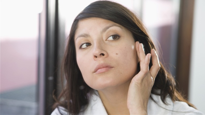 Woman checking out mole
