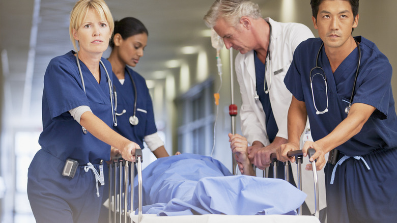 hospital personnel bringing a patient into emergency room