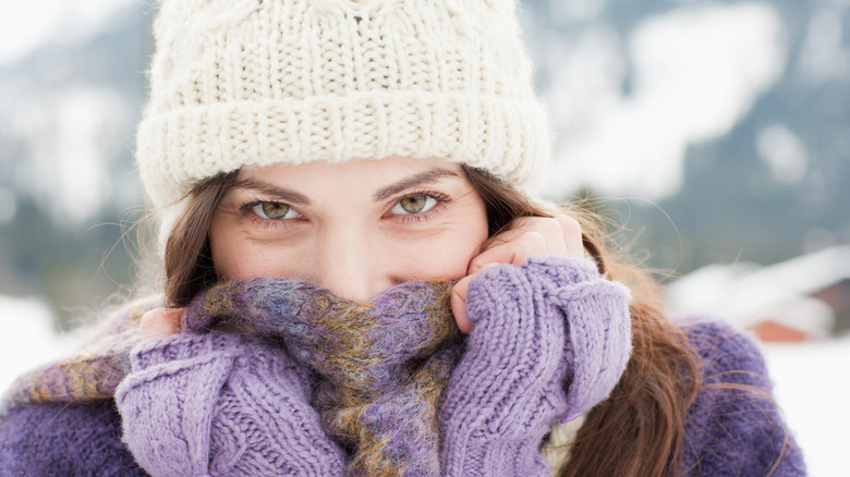 Person covering face in cold