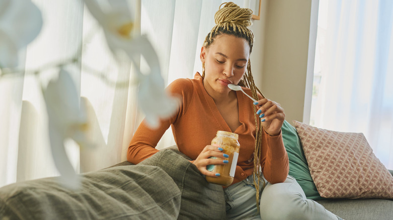 Woman eating peanut butter