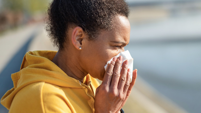 Woman sneezing during exercise