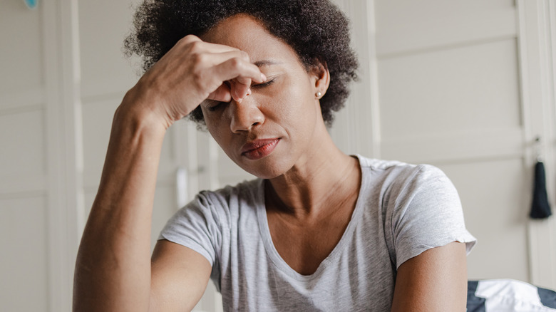 Woman rubbing eyes from drowsiness