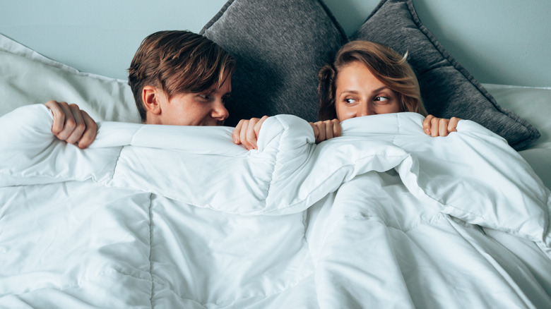 Couple in bed after sex