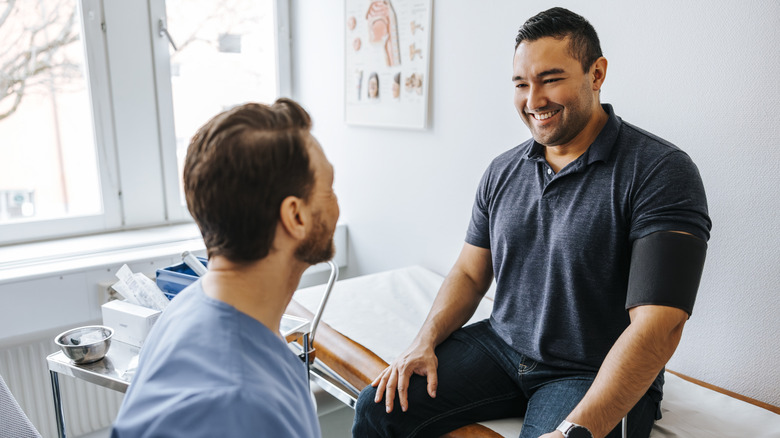 A man talking to his doctor in an exam room