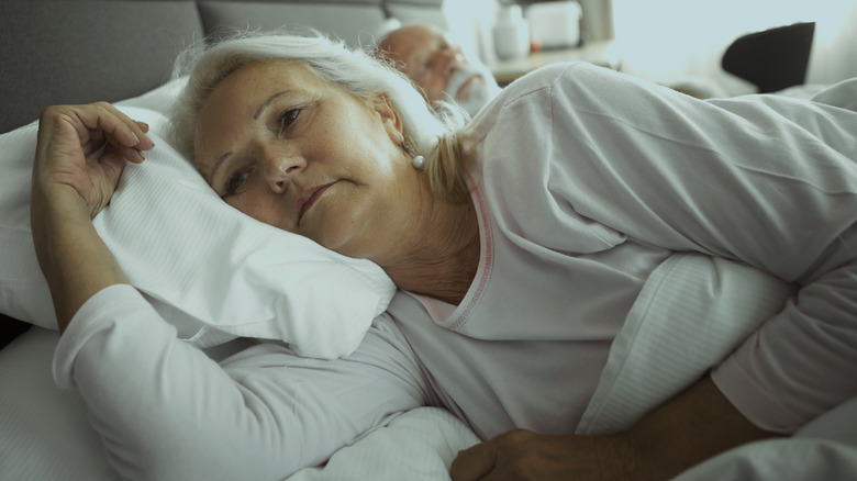 Woman lying awake in bed