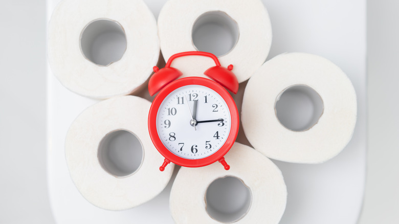 clock on rolls of toilet paper