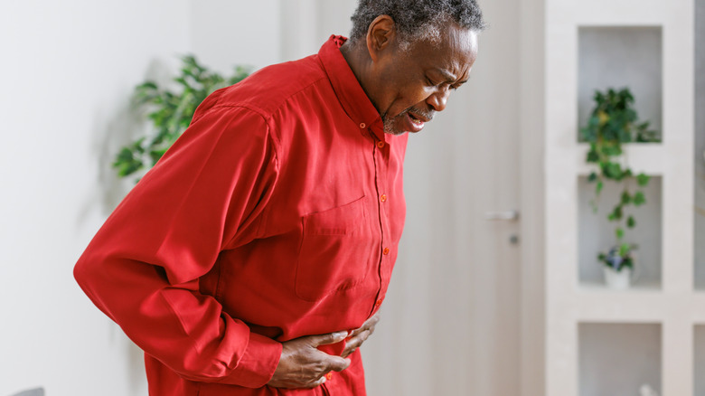 Man holding stomach in pain