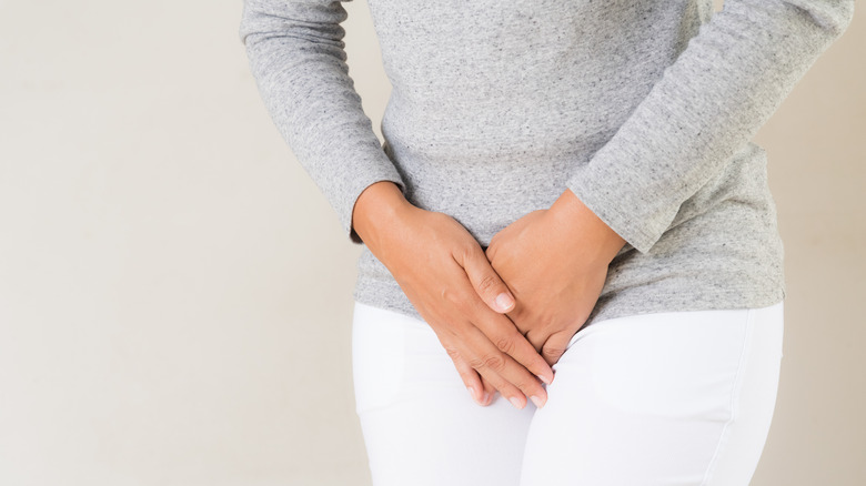 Woman with her hands on pelvis