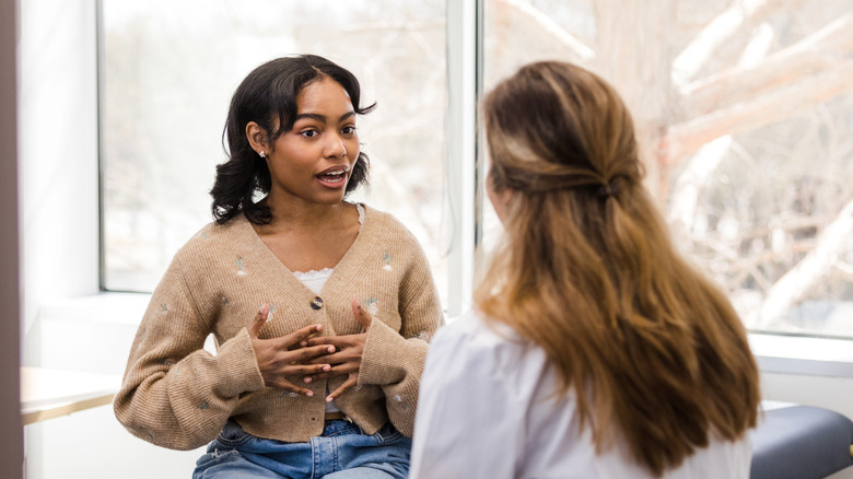 woman sharing concerns with doctor