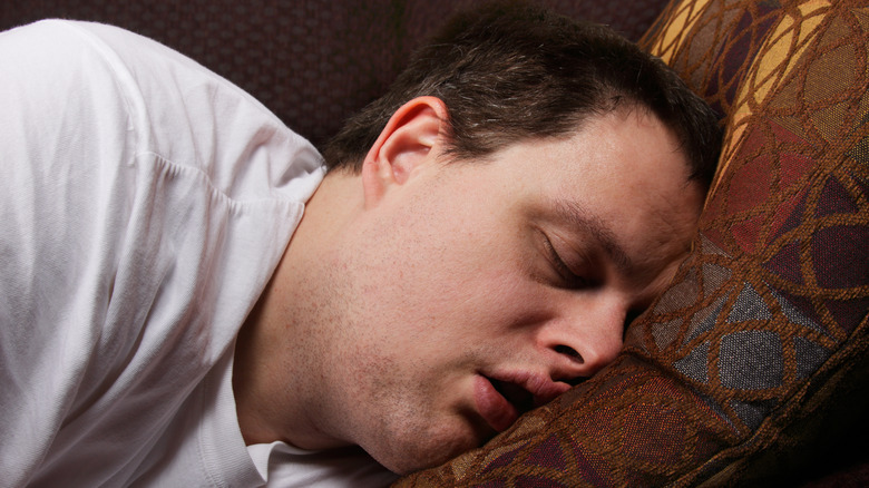 Man asleep on couch