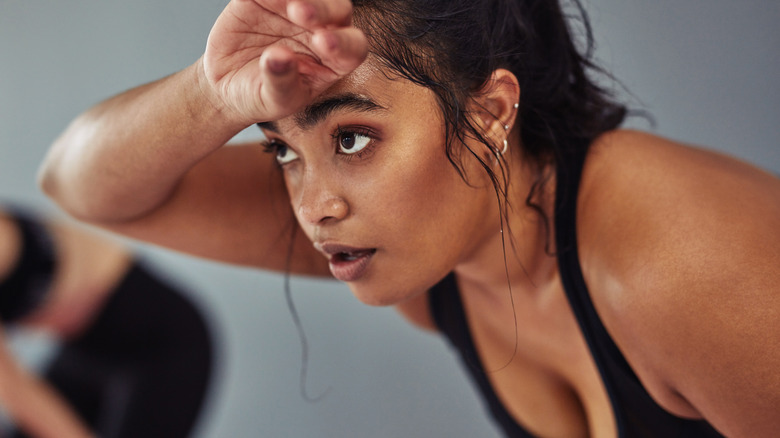 woman sweating during tough workout