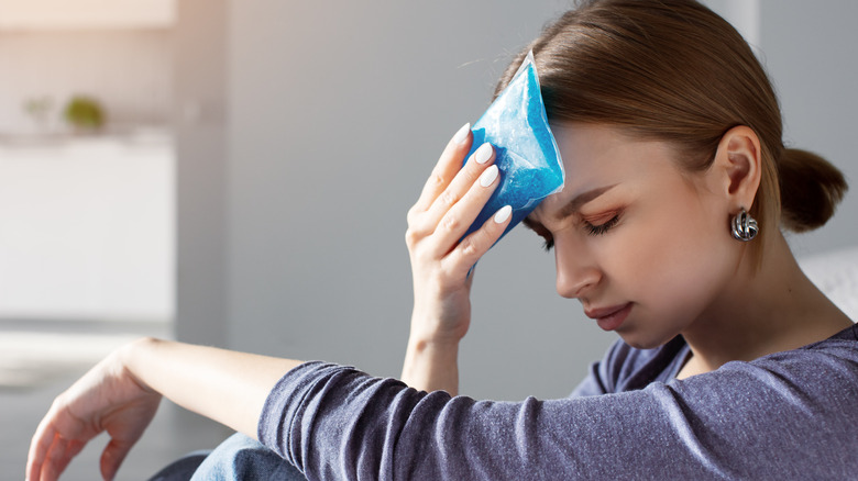 woman with a cold compress on her head