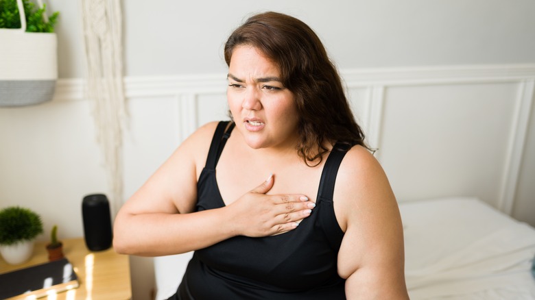 woman waking up feeling heart racing