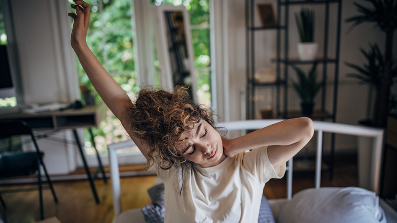 Woman waking up and stretching