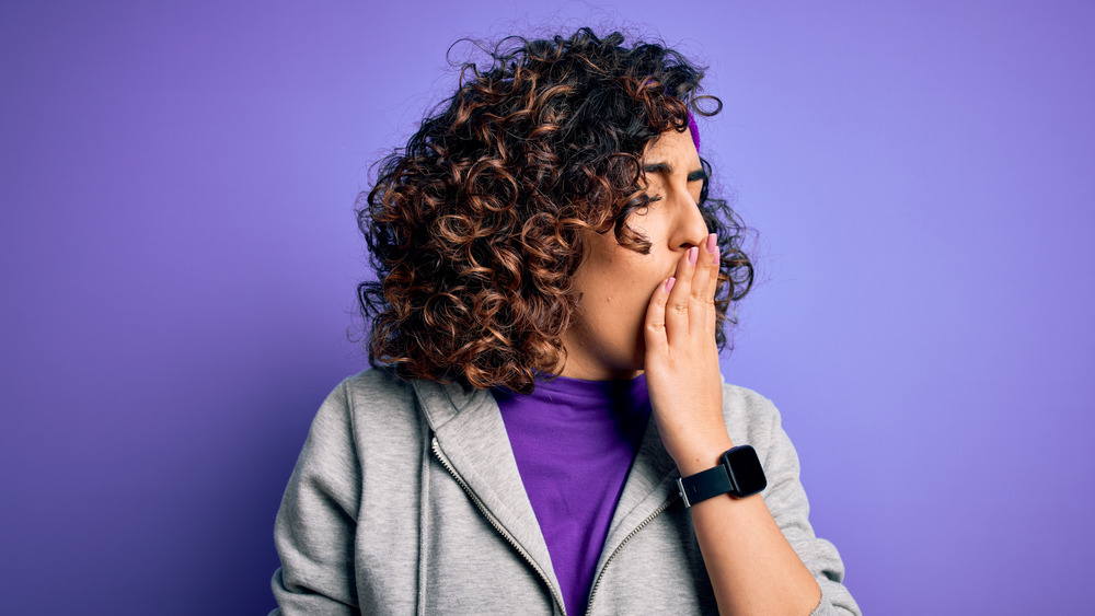 Woman in workout gear yawning