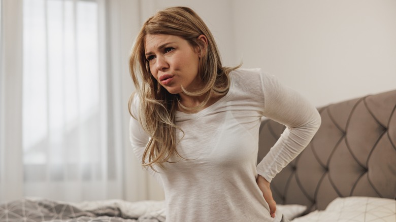 Woman holding lower back in pain