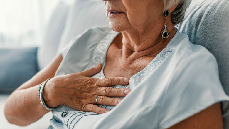 older woman grabbing her chest