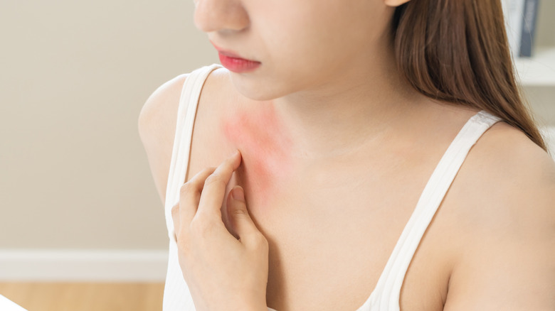 woman scratching chest