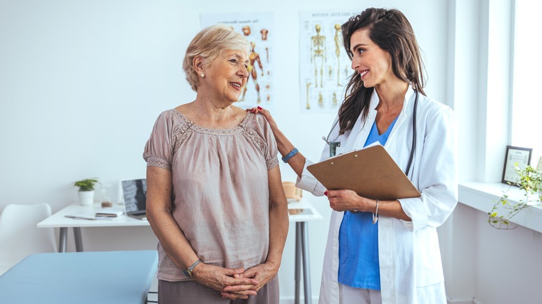 doctor with hand on patient's shoulder