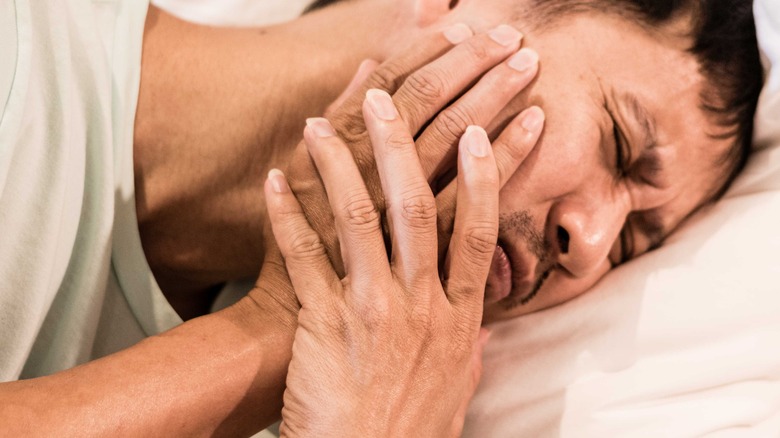 Man in bed with jaw pain