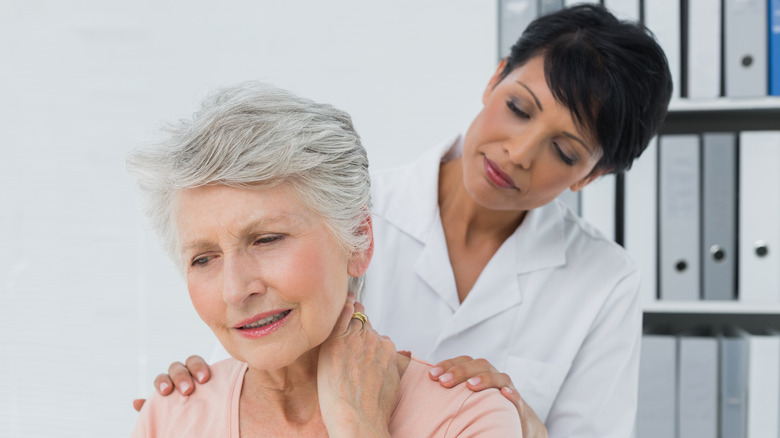 Doctor examining patient's neck