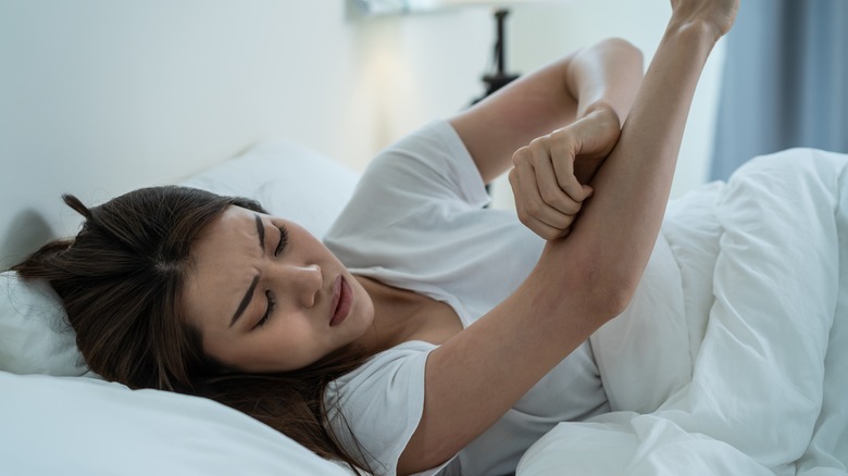 Woman touching painful arm