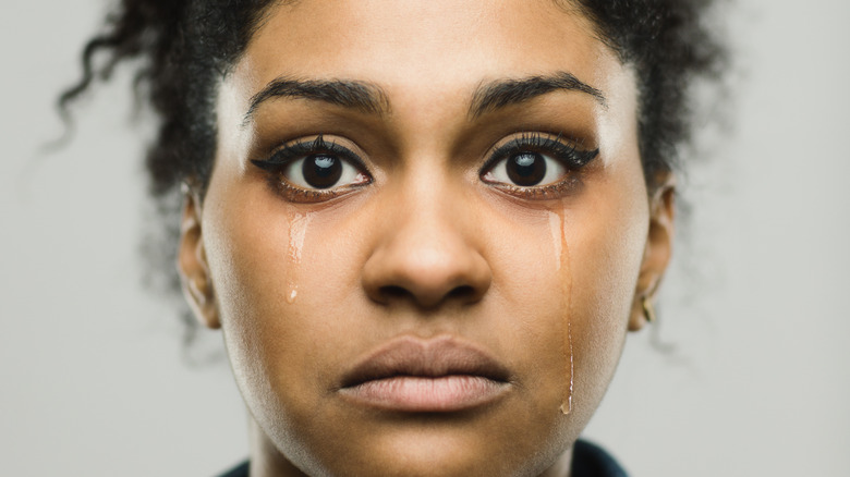 woman with tears running down cheeks