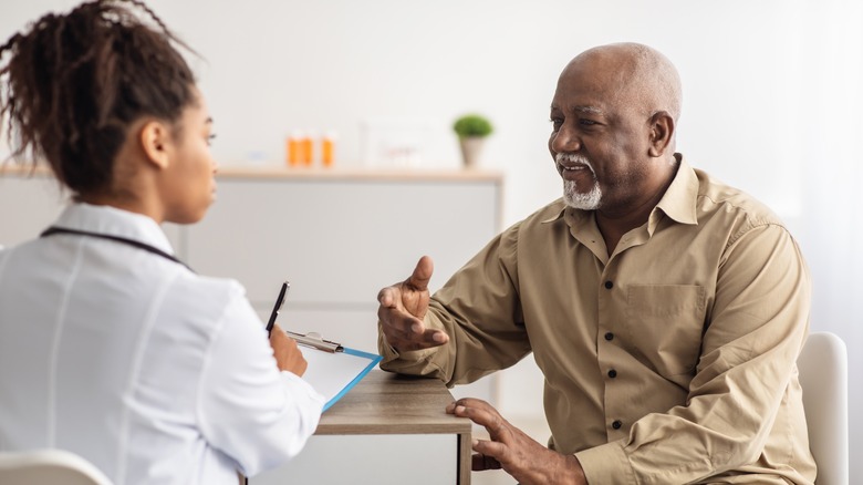 An older man talking to a doctor