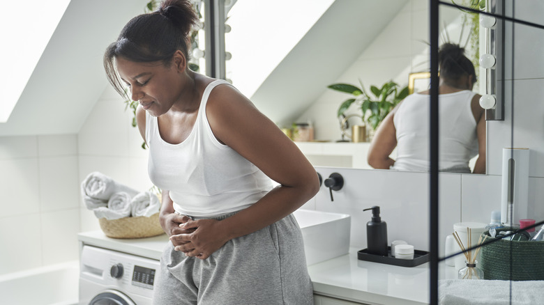 woman in bathroom in pain