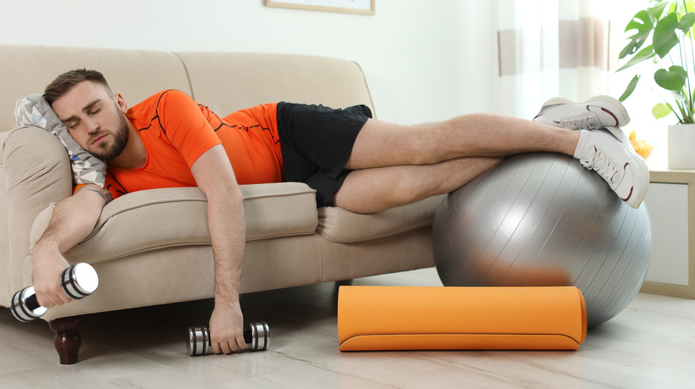 an athlete lying on sofa with workout gear