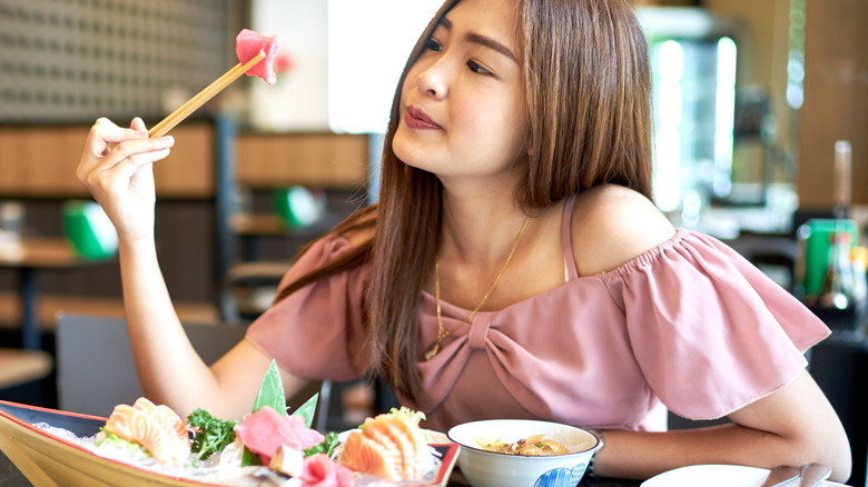 Woman eating fish