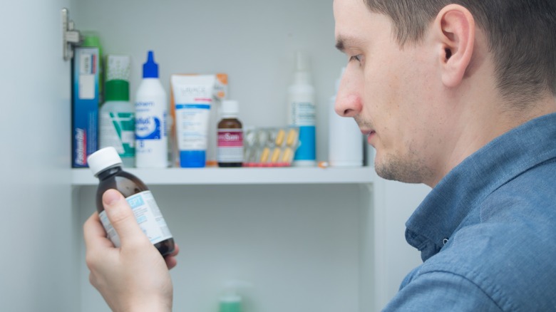 Man holding a medicine bottle