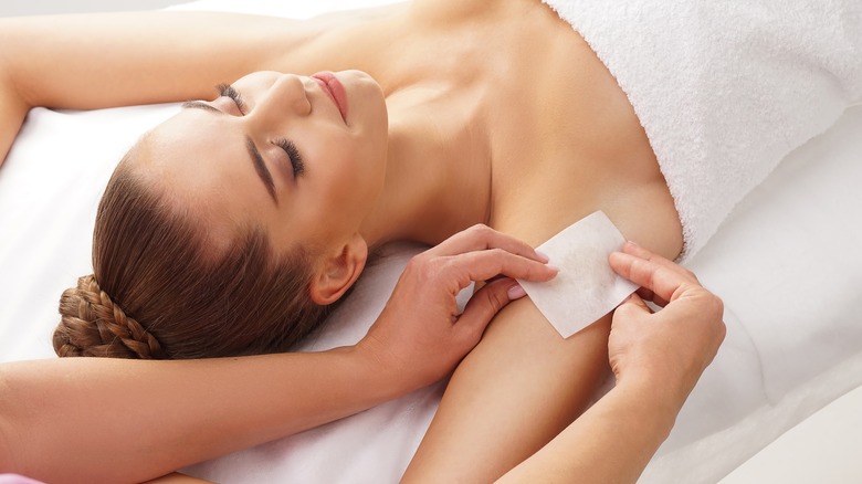 woman getting underarms waxed